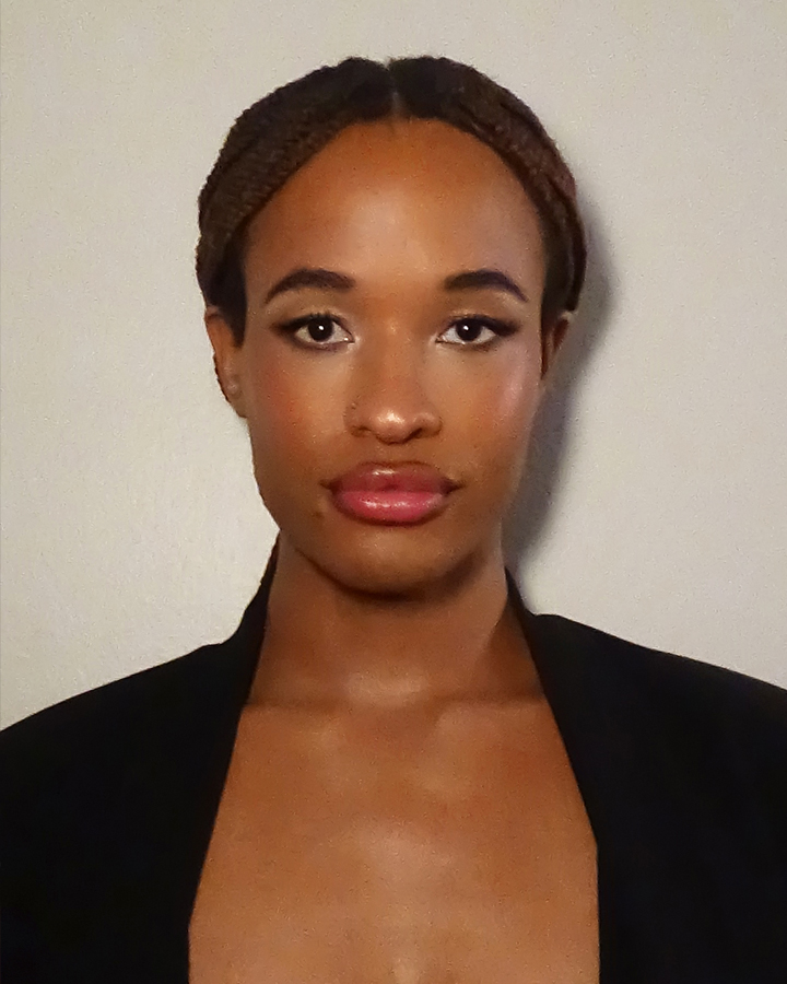 Close up portrait of Jules Crosby with soft glam makeup looking at the camera against a white backdrop